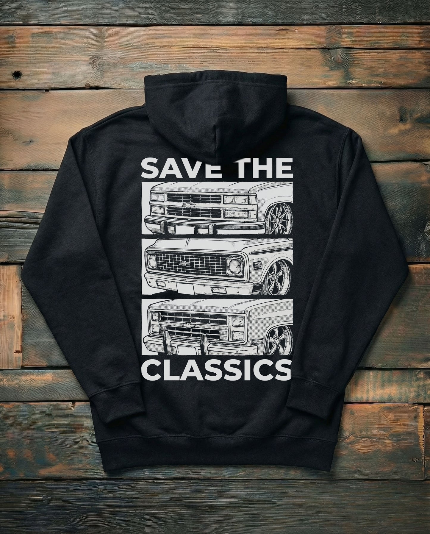 Black hoodie with 'Save the Classics' graphic on a wooden background featuring classic chevy trucks

