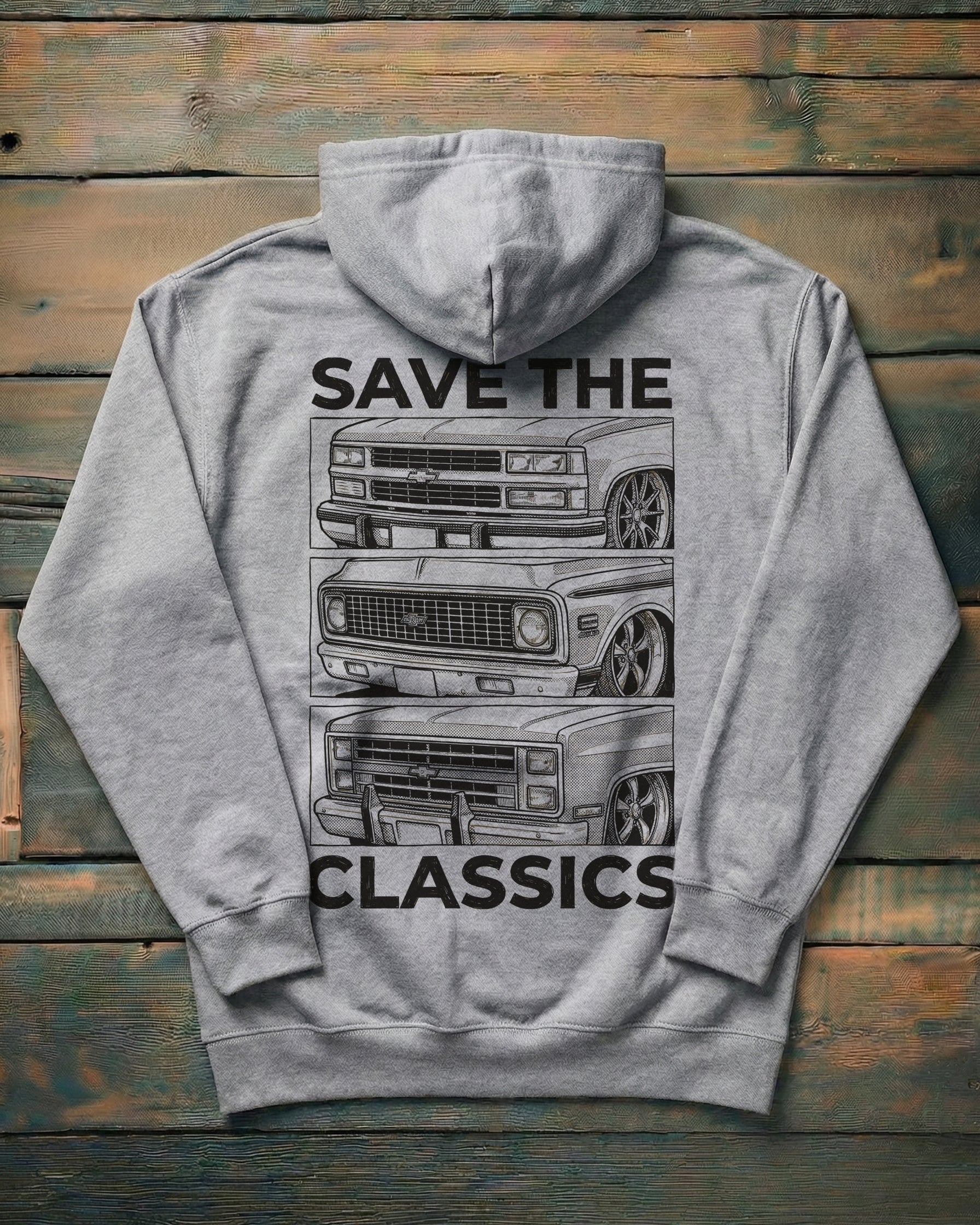 Gray hoodie with 'Save the Classics' text and truck graphics on a wooden surface