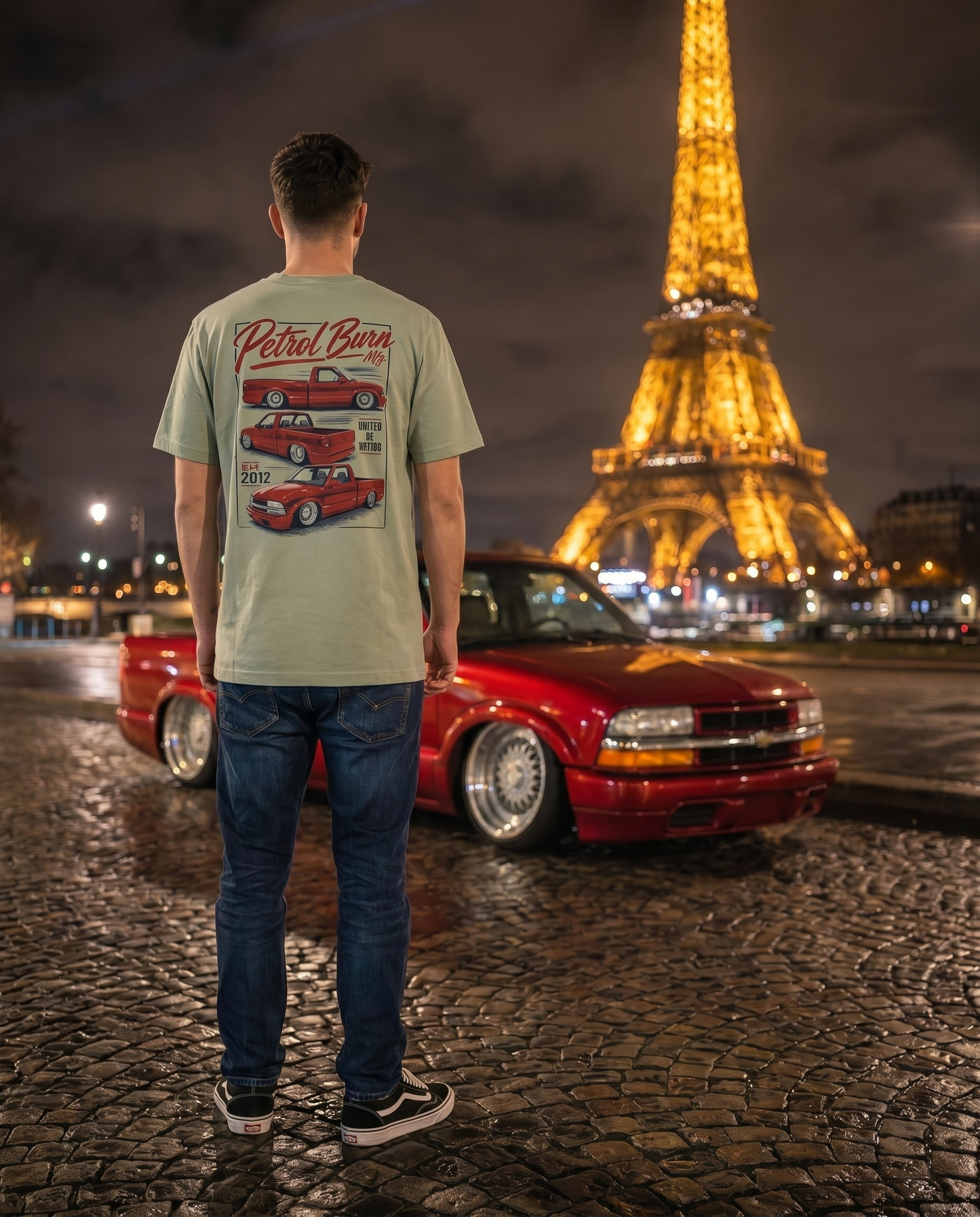 man wearing a tshirt with a bagged red chevy s10 pickup truck
