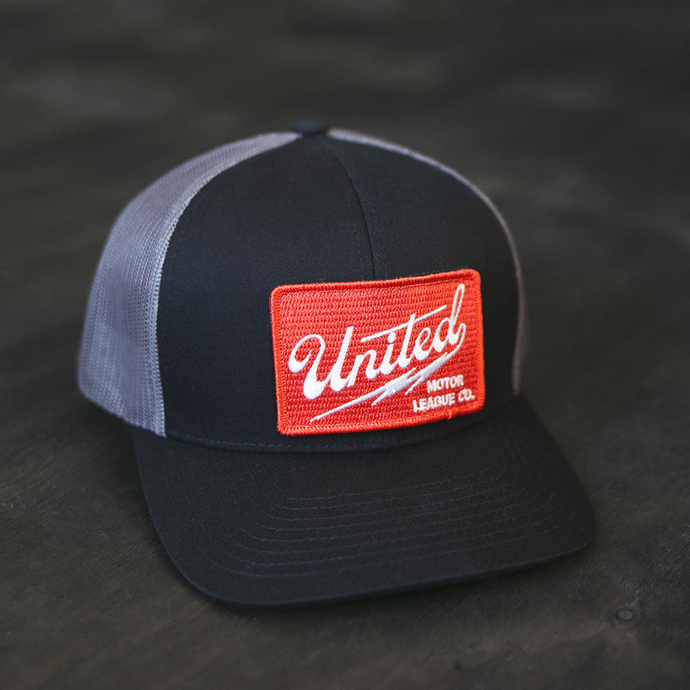 united motor league curved bill hat with red patch